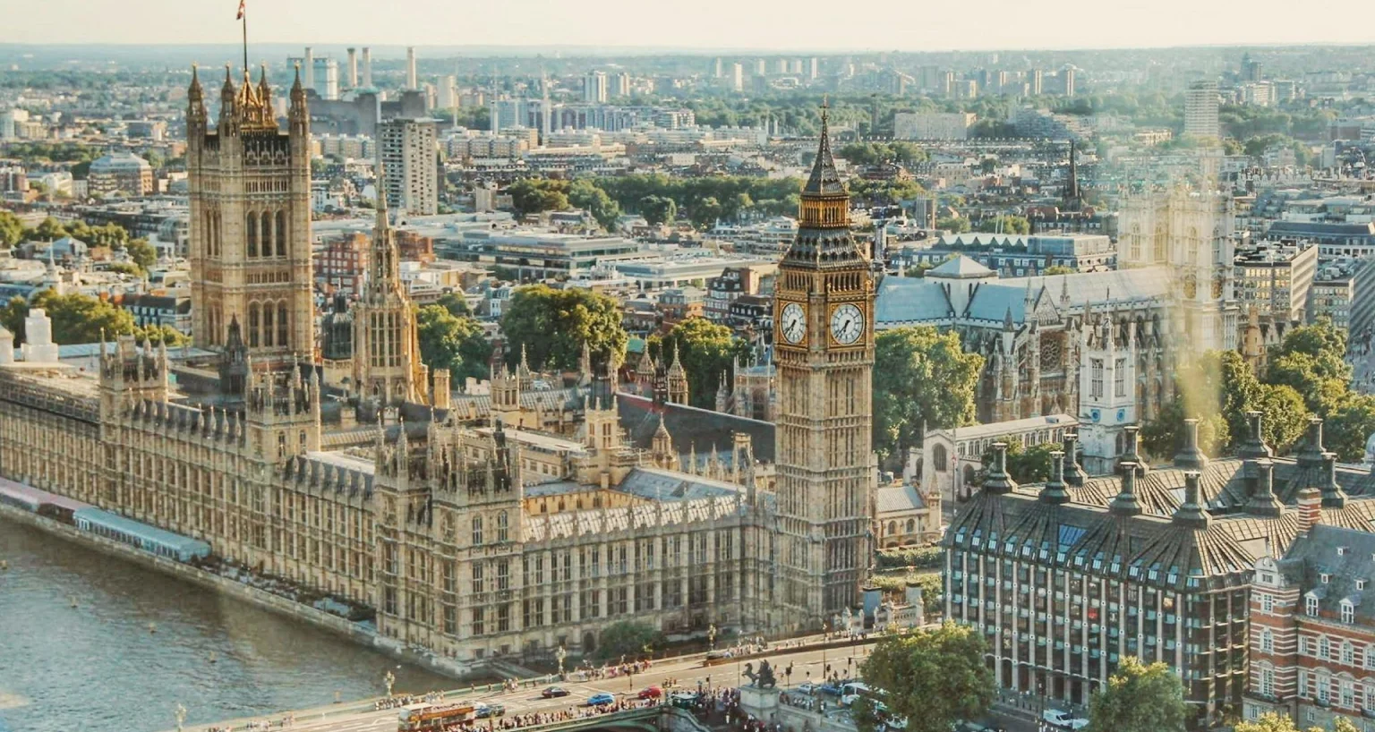 Aerial view of the Houses of Parliament and Big Ben in London on a sunny day.