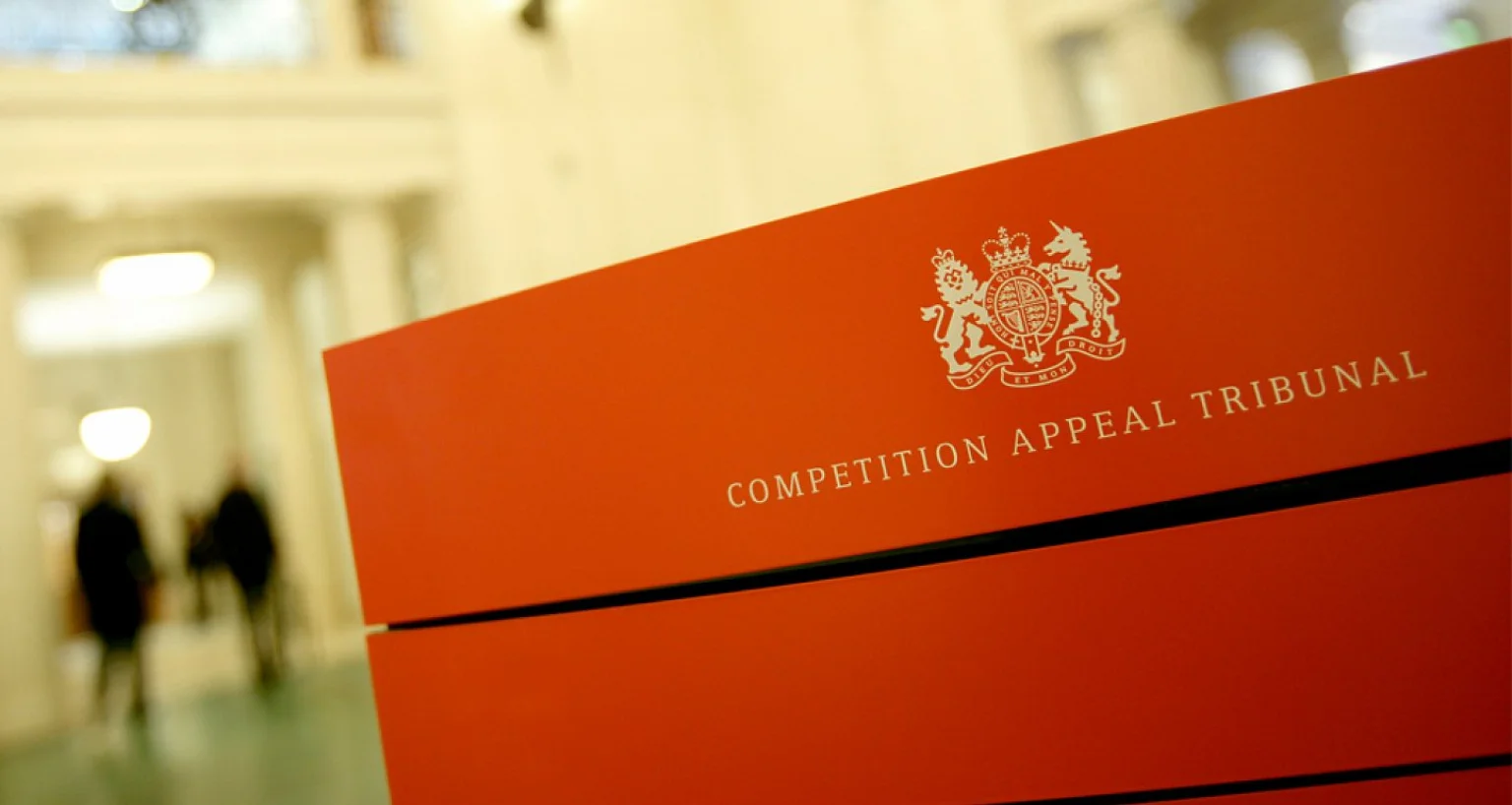 Competition Appeal Tribunal sign on a red podium inside a building.